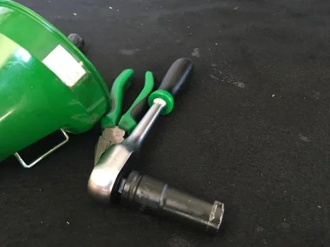 Pliers and socket wrenches are used to convert motorcycle lubricants. Stock Photos