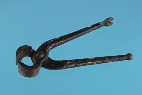 Pliers on a blue  background. Stock Photos