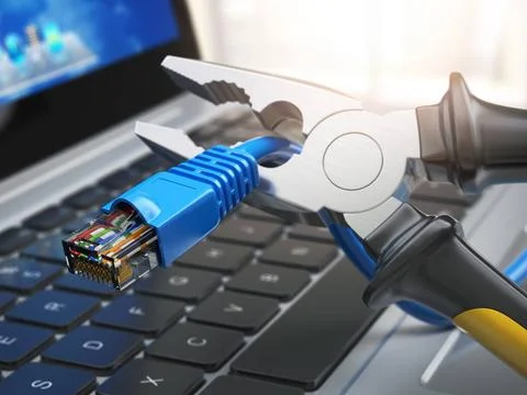 Pliers cutting lan network computer cable over laptop keyboard. Internet c... Stock Photos