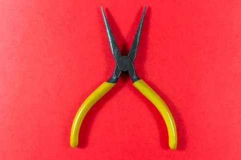 Pliers isolated on a red background Stock Photos