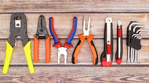 Pliers moving on the wooden table with construction and work tools - Stop motion Stock Footage 124820176