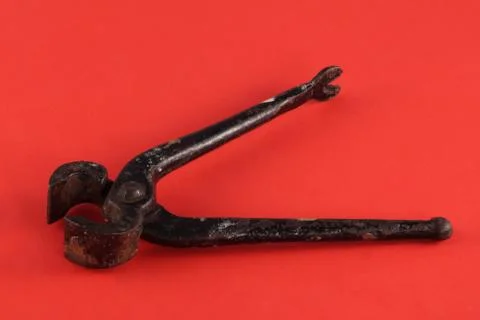 Pliers on a red  background. Stock Photos