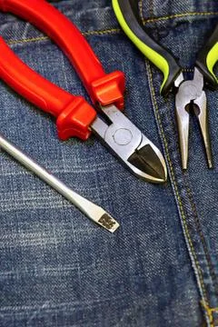 Pliers red screwdriver work tool electrician engineering background Stock Photos