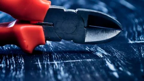 Pliers for repair work lying on the table. Repair tools in the h Stock Photos