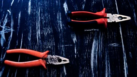 Pliers for repair work lying on the table. Repair tools in the h Stock Photos