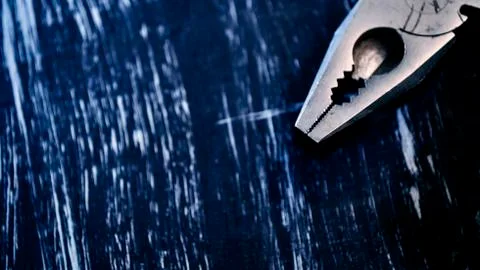Pliers for repair work lying on the table. Repair tools in the h Stock Photos