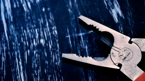 Pliers for repair work lying on the table. Repair tools in the h Stock Photos