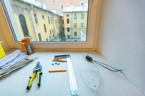 Pliers, scale, protective glasse, working pencils, bits, lamp with wires Stock Photos
