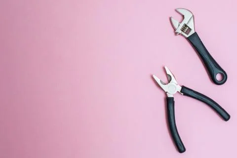 Pliers on tabletop: pink creative background for custom diy message. Stock Photos