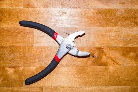 Pliers on the working surface I Stock Photos