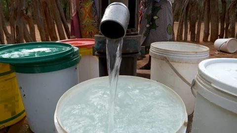 The plight for fresh water.Cropped close-up view of water in containers Stock Footage 112881362