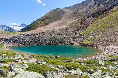 The plodersee in the pitztal in austria with a ski piste in the background Stock Photos