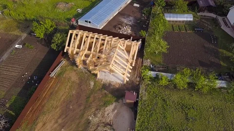 Plot with construction of wooden house. Clip. Top view on frame of wooden house Stock Footage 115659011