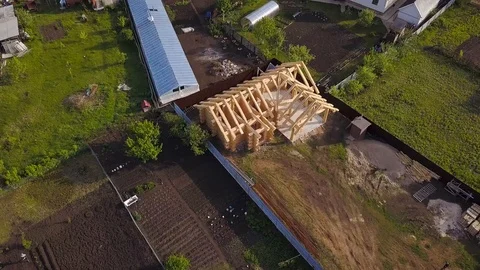 Plot with construction of wooden house. Clip. Top view on frame of wooden house Stock Footage 115659084
