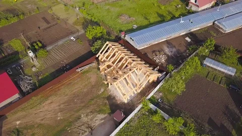 Plot with construction of wooden house. Clip. Top view on frame of wooden house Stock Footage 115659137
