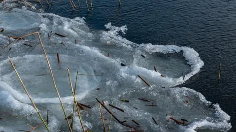 Plot of frozen river covered with ice and snow. Stock Photos