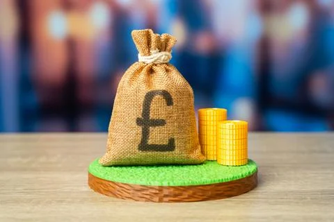 A plot of land and a british pound money bag. Land value, determining the v.. Stock Photos