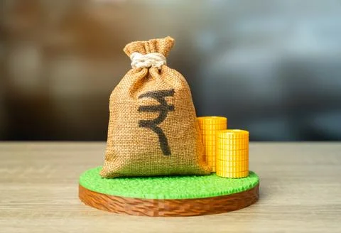 A plot of land and a Indian rupee money bag. Land value, determining the va.. 写真素材