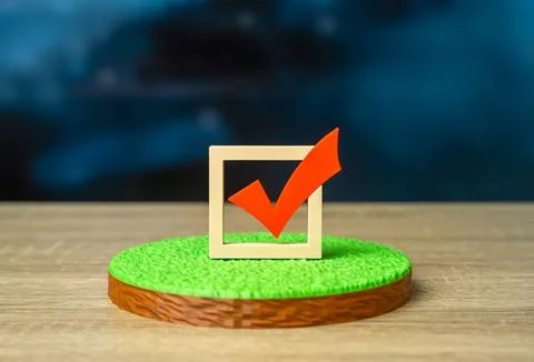A plot of land and a red check mark. Voting districts. Agreement verification Stock Photos