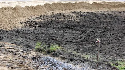 Plot of land, covered with peat, which is dug out the earth excavator in p... Stock Photos