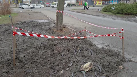 Plot of land fenced with red-white signal tape. Danger warning on city street Stock Footage 145467484