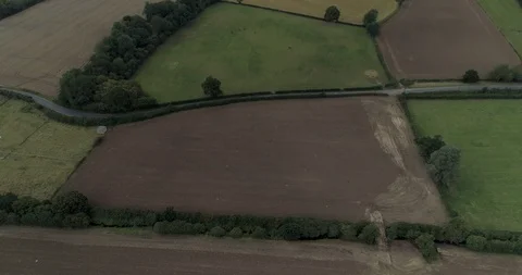 Plot of land next to country road in English countryside drone aerial 4k Vídeos de archivo 125752843