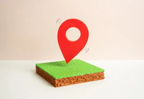 A plot of land with a red geolocation marker. Land market and cadastral regis Stock Photos