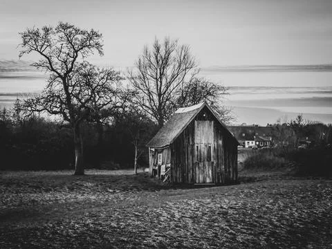 On the plot of land stands an ancient crooked wooden house Fotos de archivo