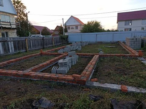 A plot of land on which construction of a foundation has begun Stock Photos