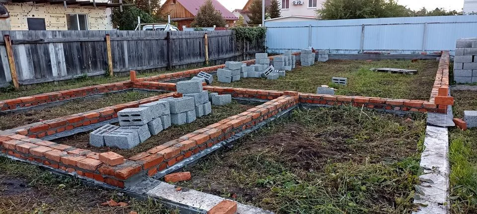 A plot of land on which construction of a foundation has begun Stock Photos