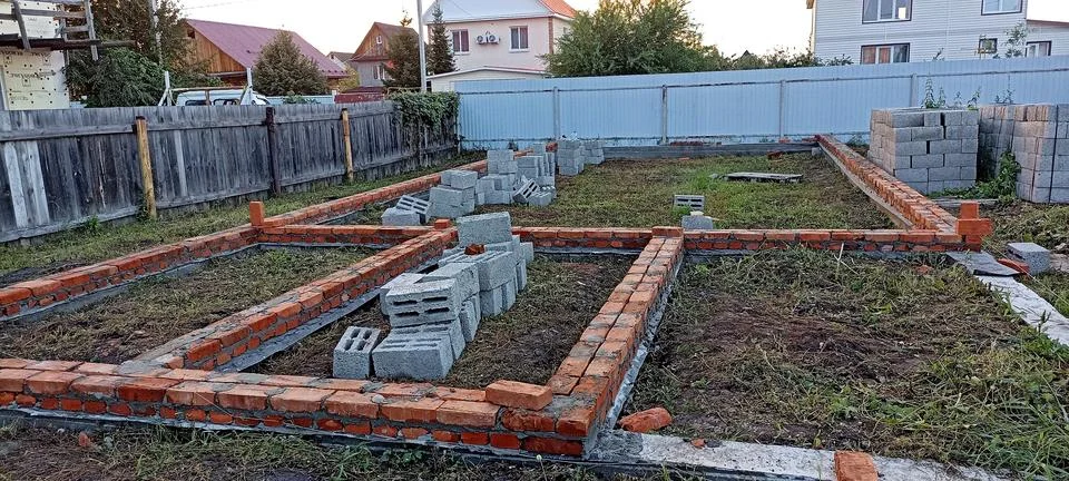 A plot of land on which construction of a foundation has begun Stock Photos