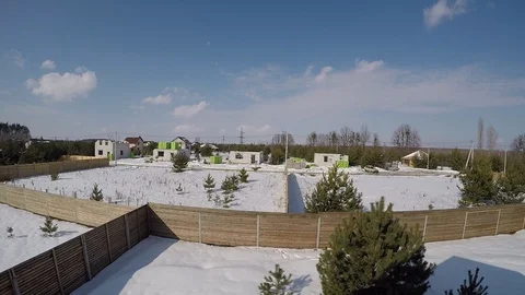 Plot of land in winter. Construction of a private house. Fence on the land in wi Stockbeeldmateriaal 86952991