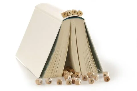 Plot, message spelled out in wooden letters on top of a book that is set up like Fotos de archivo
