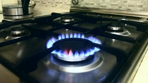 Plotagraph - Gas stove with blue flame in the kitchen Stock Footage 100793754