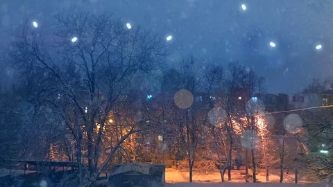 Plotagraph - winter weather on the yard outside, falling snow, merry lights on Stock Footage 100793378