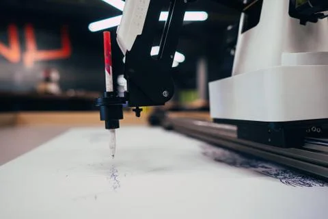 Plotter draws a pen drawing on a sheet of white paper Fotos de archivo