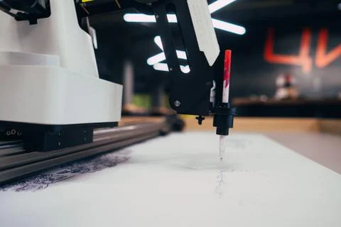 Plotter draws a pen drawing on a sheet of white paper Stock Photos