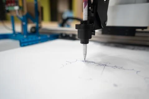 Plotter draws a pen drawing on a sheet of white paper Fotos de archivo