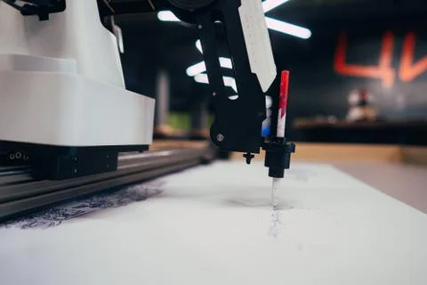 Plotter draws a pen drawing on a sheet of white paper Stock Photos