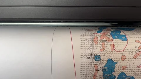 A plotter prints a comprehensive terrain map, showcasing elevation difference 動画素材 307219316