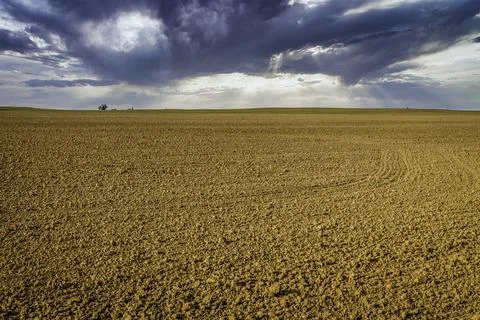 Ploughed Field with Dramatic Sky in the Background Stock Photos
