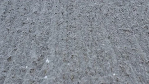 Ploughed soil under snow 4K aerial video Stock Footage 172124754