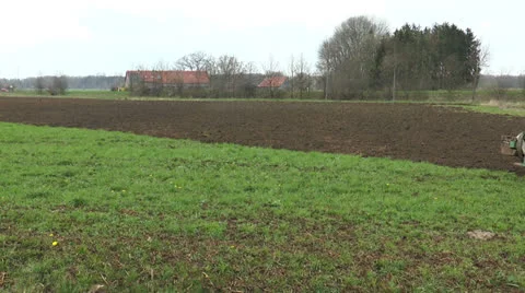 Ploughing farmland with tractor and plough Stock Footage