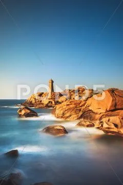 Ploumanach lighthouse sunset in pink granite coast, Brittany, France. Stock Photos