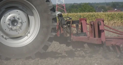 Plow Behind The Tractor Close Up Driver's Silhouette Flying Dust Road and Stock Footage 53627048