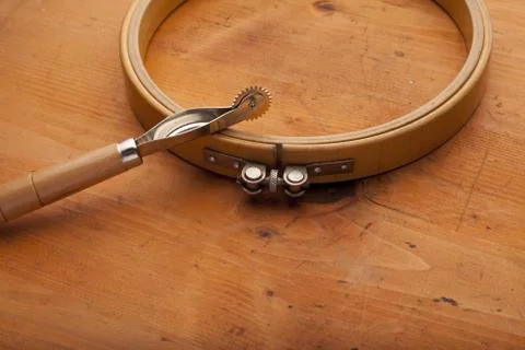 Plow with needlework ring craft concept on wooden texture Stock Photos