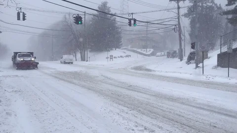 Plow Truck Drives Through Intersection During Snowstorm Stock Footage 85282481