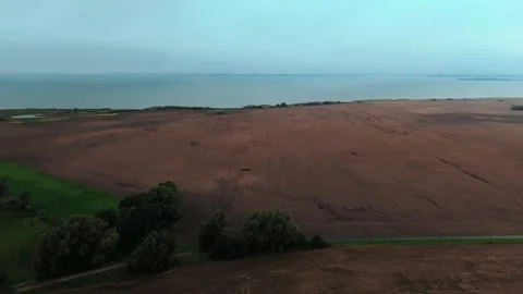 Plowed Field and Willow Trees Above the Ruegen Coast Aerial View Stock Footage 346056878