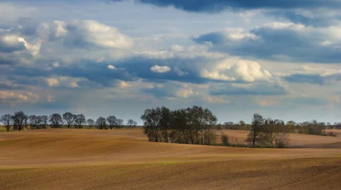 Plowed field landscape under blue sky with clouds, 4k timelapse Vídeos de archivo 62359155