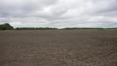 Plowed field under cloudy sky 動画素材 275166486